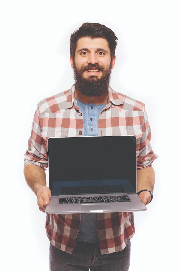 Happy smiling bearded man holding laptop